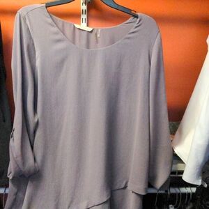 Top with flowing hem. Scoop neck.